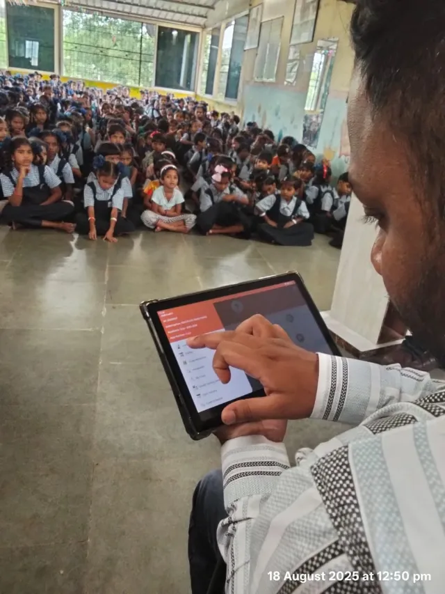 EduSoulX tablet shown at a school gathering